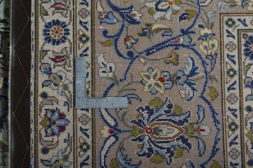 Backside of handmade 2000s Kashan rug showing knot structure and weave density