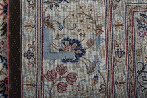 Backside of handmade New Kashan rug showing knot structure and weave density