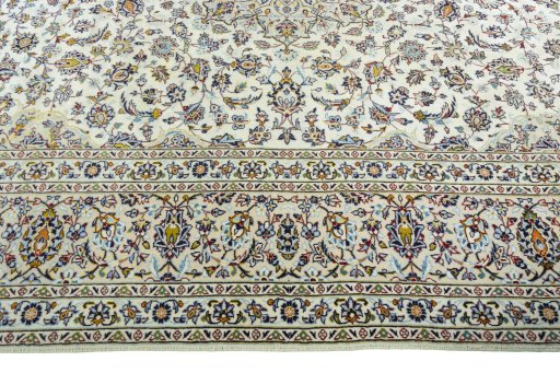 Corner detail of 2000s Kashan rug showing border pattern and Wool pile