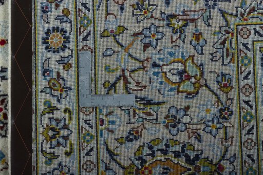 Backside of handmade 2000s Kashan rug showing knot structure and weave density