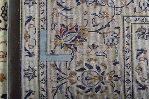 Backside of handmade 2000s Kashan rug showing knot structure and weave density
