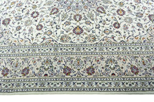 Corner detail of 2000s Kashan rug showing border pattern and Wool pile