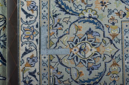 Backside of handmade 2000s Kashan rug showing knot structure and weave density