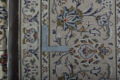 Backside of handmade 2000s Kashan rug showing knot structure and weave density