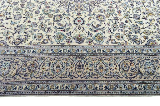 Corner detail of 2000s Kashan rug showing border pattern and Wool pile