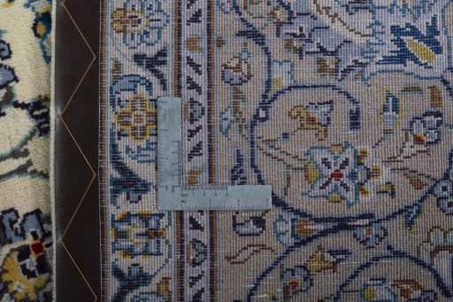 Backside of handmade 2000s Kashan rug showing knot structure and weave density