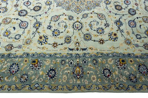Corner detail of 2000s Kashan rug showing border pattern and Wool pile