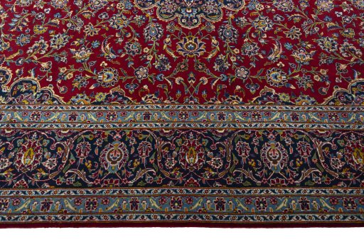 Corner detail of 2000s Kashan rug showing border pattern and Wool pile