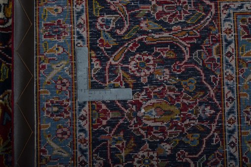 Backside of handmade 2000s Kashan rug showing knot structure and weave density