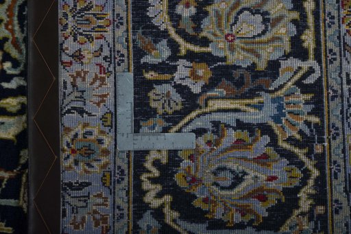 Backside of handmade 2000s Kashan rug showing knot structure and weave density