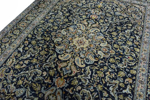 Backside of handmade 2000s Kashan rug showing knot structure and weave density