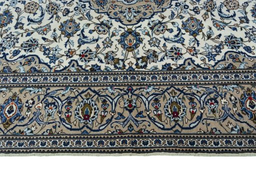 Corner detail of 2000s Kashan rug showing border pattern and Wool pile