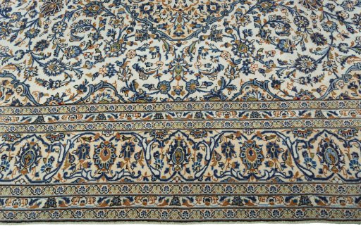 Corner detail of 2000s Kashan rug showing border pattern and Wool pile