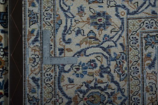 Backside of handmade 2000s Kashan rug showing knot structure and weave density