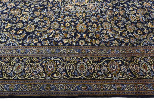 Corner detail of 2000s Kashan rug showing border pattern and Wool pile