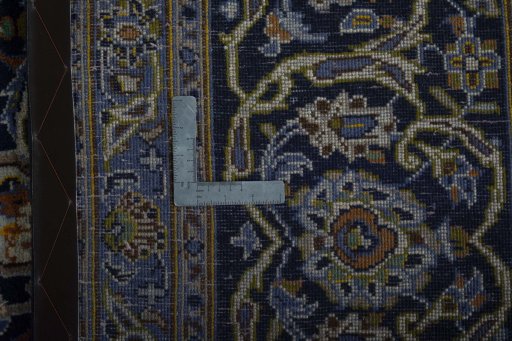 Backside of handmade 2000s Kashan rug showing knot structure and weave density