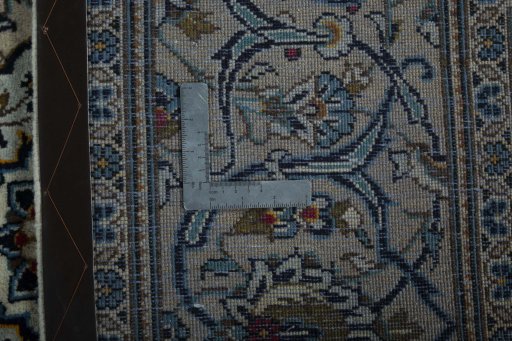 Backside of handmade 2000s Kashan rug showing knot structure and weave density