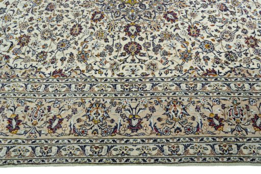 Corner detail of 2000s Kashan rug showing border pattern and Wool pile