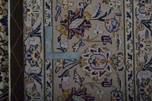 Backside of handmade 2000s Kashan rug showing knot structure and weave density