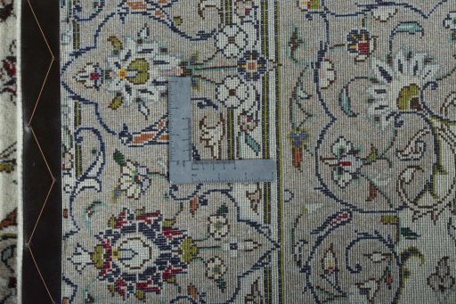 Backside of handmade 2000s Kashan rug showing knot structure and weave density