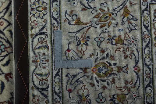 Backside of handmade 2000s Kashan rug showing knot structure and weave density