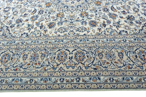 Corner detail of 2000s Kashan rug showing border pattern and Wool pile