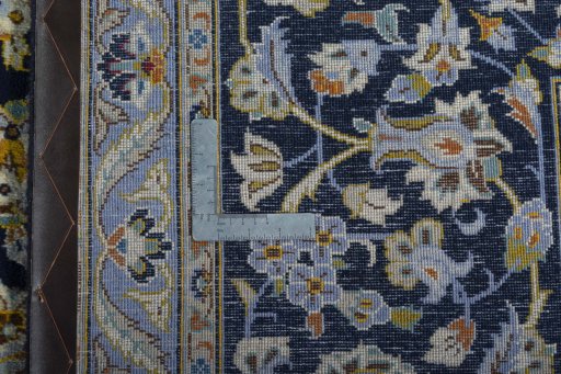 Backside of handmade 1970s Kashan rug showing knot structure and weave density