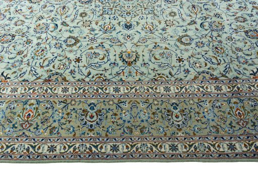 Corner detail of 2000s Kashan rug showing border pattern and Wool pile