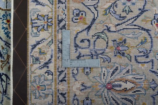 Backside of handmade 2000s Kashan rug showing knot structure and weave density