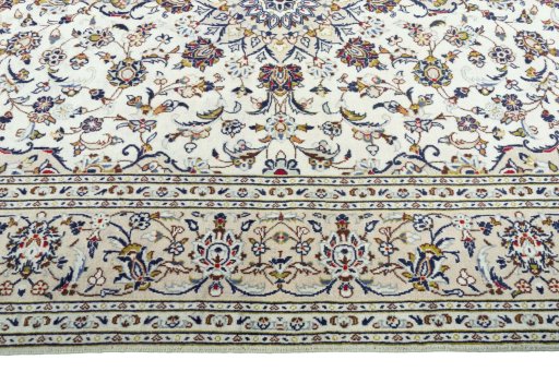 Corner detail of 2000s Kashan rug showing border pattern and Wool pile
