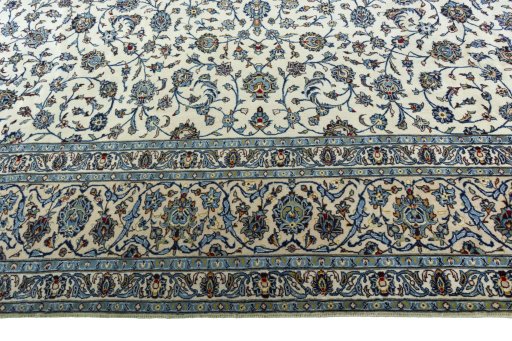 Corner detail of 2000s Kashan rug showing border pattern and Wool pile
