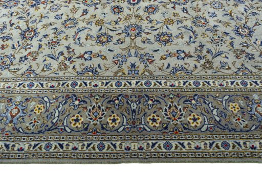 Corner detail of 2000s Kashan rug showing border pattern and Wool pile