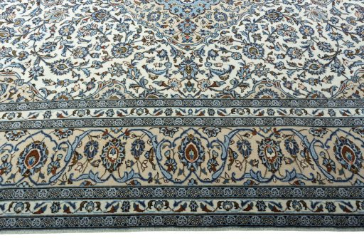 Corner detail of 2000s Kashan rug showing border pattern and Wool pile