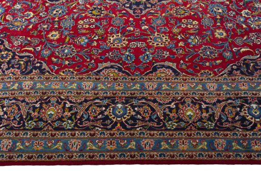 Corner detail of 2000s Kashan rug showing border pattern and Wool pile