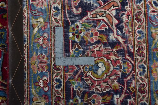 Backside of handmade 2000s Kashan rug showing knot structure and weave density