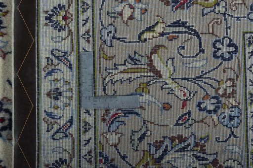 Backside of handmade 2000s Kashan rug showing knot structure and weave density