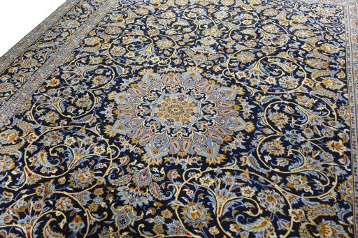 Backside of handmade 2000s Kashan rug showing knot structure and weave density