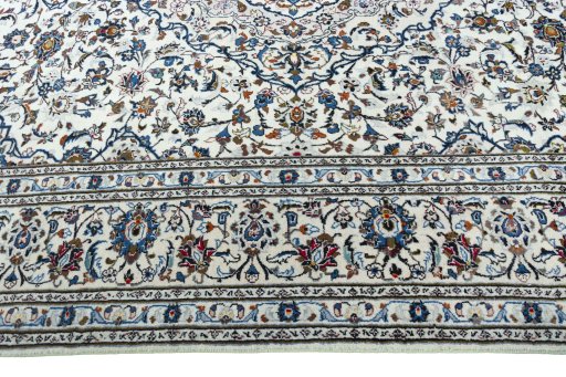 Corner detail of 2000s Kashan rug showing border pattern and Wool pile