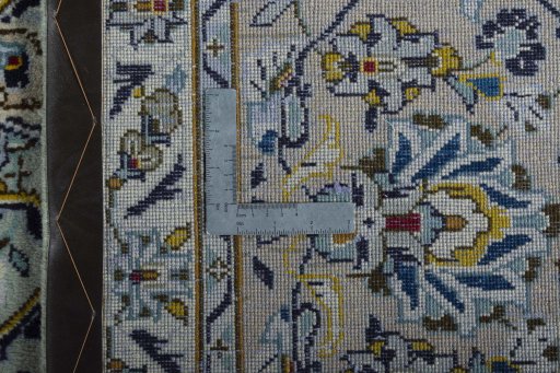Backside of handmade 2000s Kashan rug showing knot structure and weave density