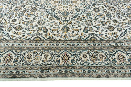 Corner detail of 2000s Kashan rug showing border pattern and Wool pile