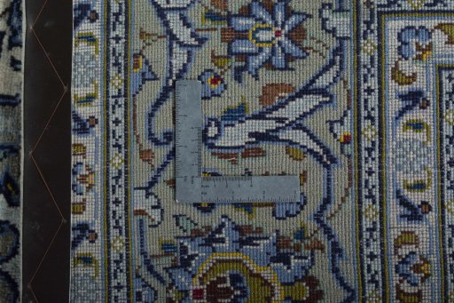 Backside of handmade 2000s Kashan rug showing knot structure and weave density