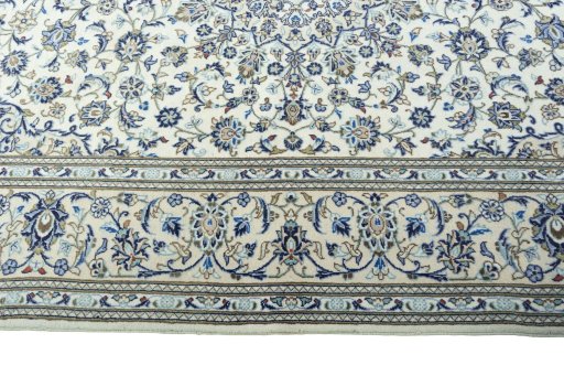 Corner detail of 2000s Kashan rug showing border pattern and Wool pile