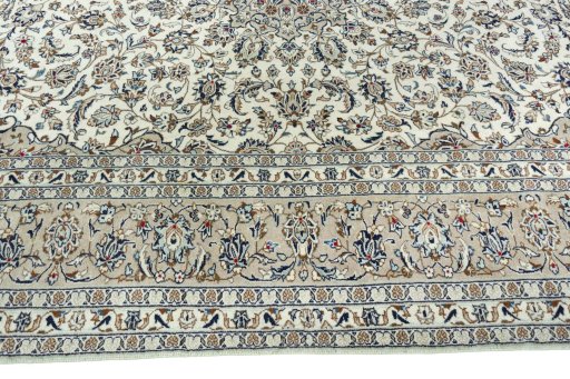 Corner detail of 2000s Kashan rug showing border pattern and Wool pile