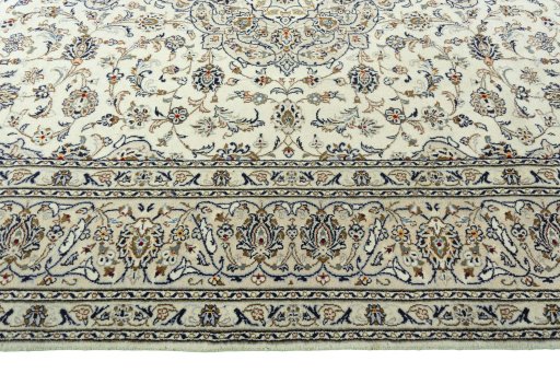 Corner detail of 2000s Kashan rug showing border pattern and Wool pile
