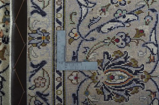 Backside of handmade 2000s Kashan rug showing knot structure and weave density
