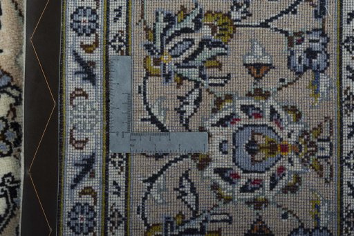 Backside of handmade 2000s Kashan rug showing knot structure and weave density
