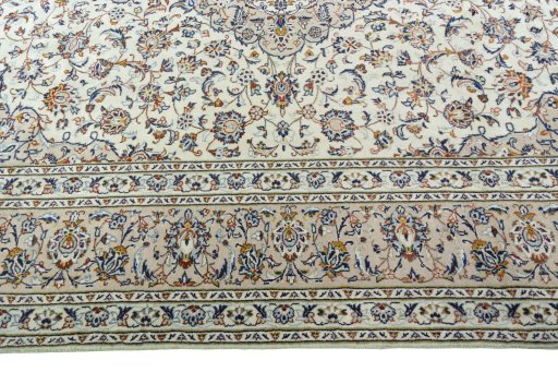 Corner detail of 2000s Kashan rug showing border pattern and Wool pile