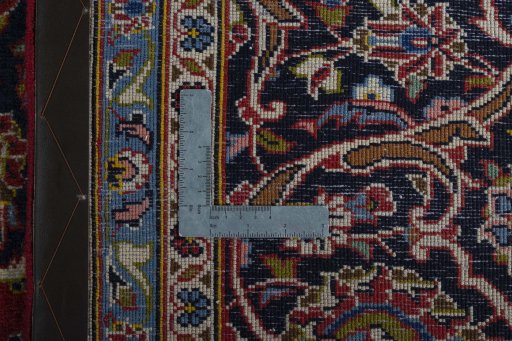 Backside of handmade 2000s Kashan rug showing knot structure and weave density