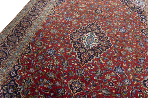 Backside of handmade 2000s Kashan rug showing knot structure and weave density