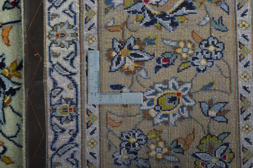 Backside of handmade 2000s Kashan rug showing knot structure and weave density
